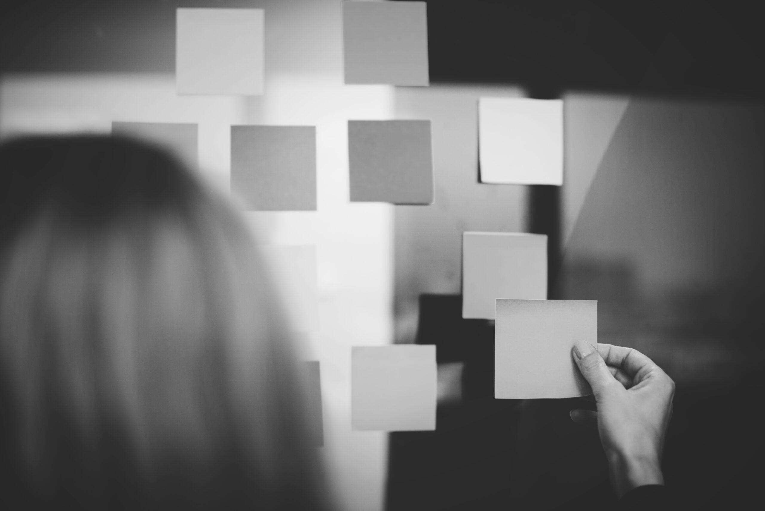 Woman attaching a note to a board